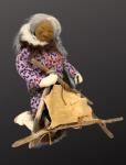 Woman Cleaning Seal Skin with Ulu Knife Doll